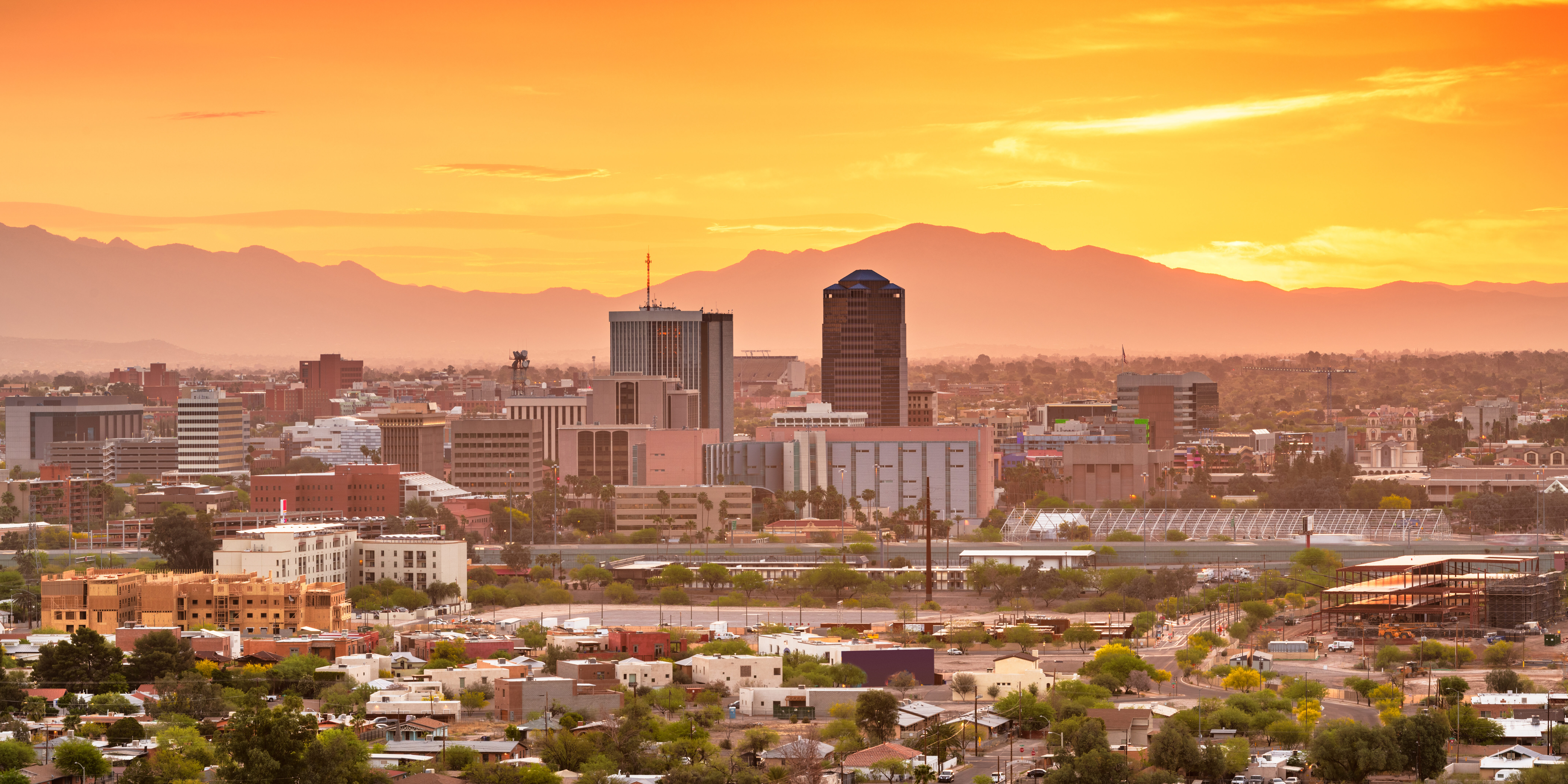 Tucson, Arizona, USA downtown city skyline with mountains at twilight.